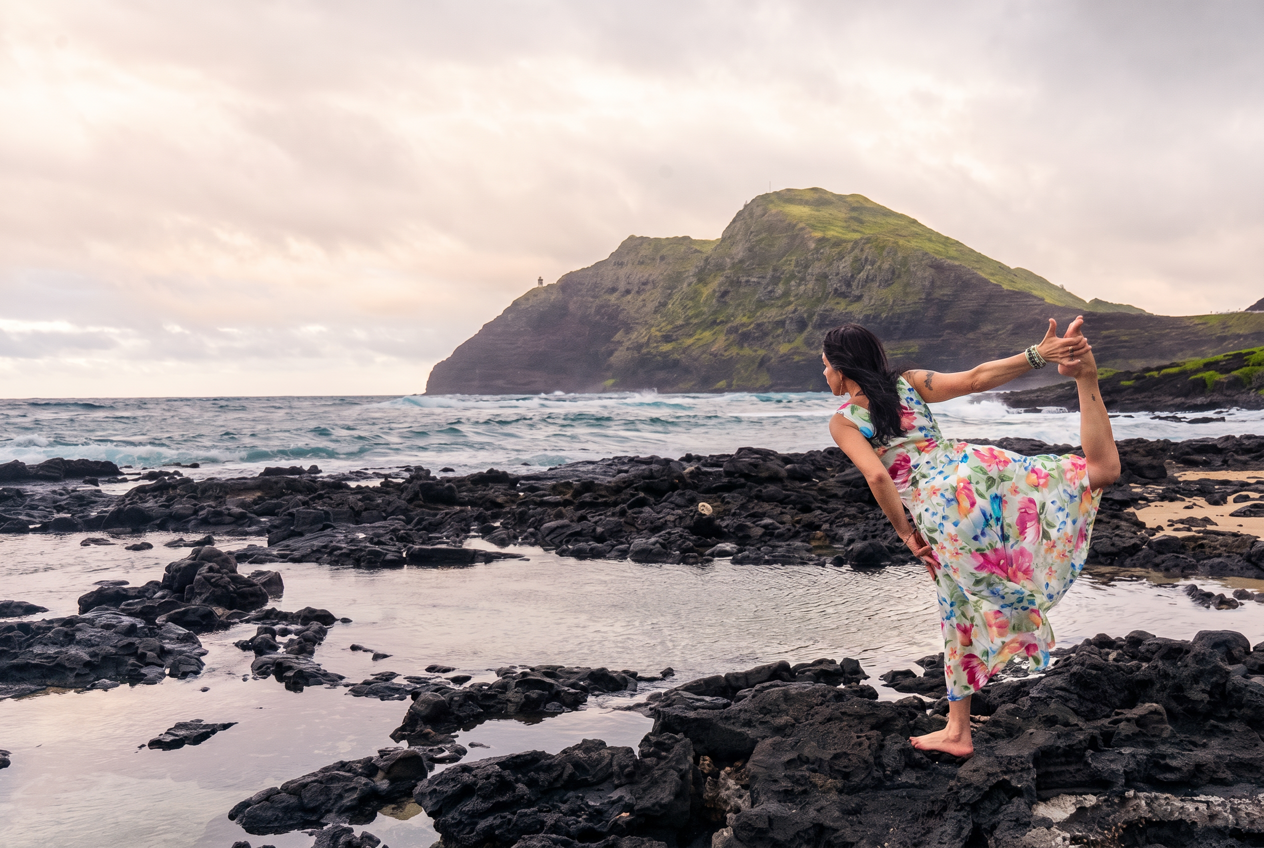 Golden hour over a lush Hawaiian coastline, turquoise ocean meeting green volcanic cliffs